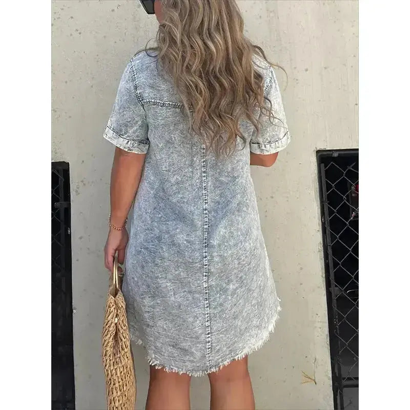 Women’s short sleeve denim button-down dress with raw hem in a casual style by Plush Fashion Hub.