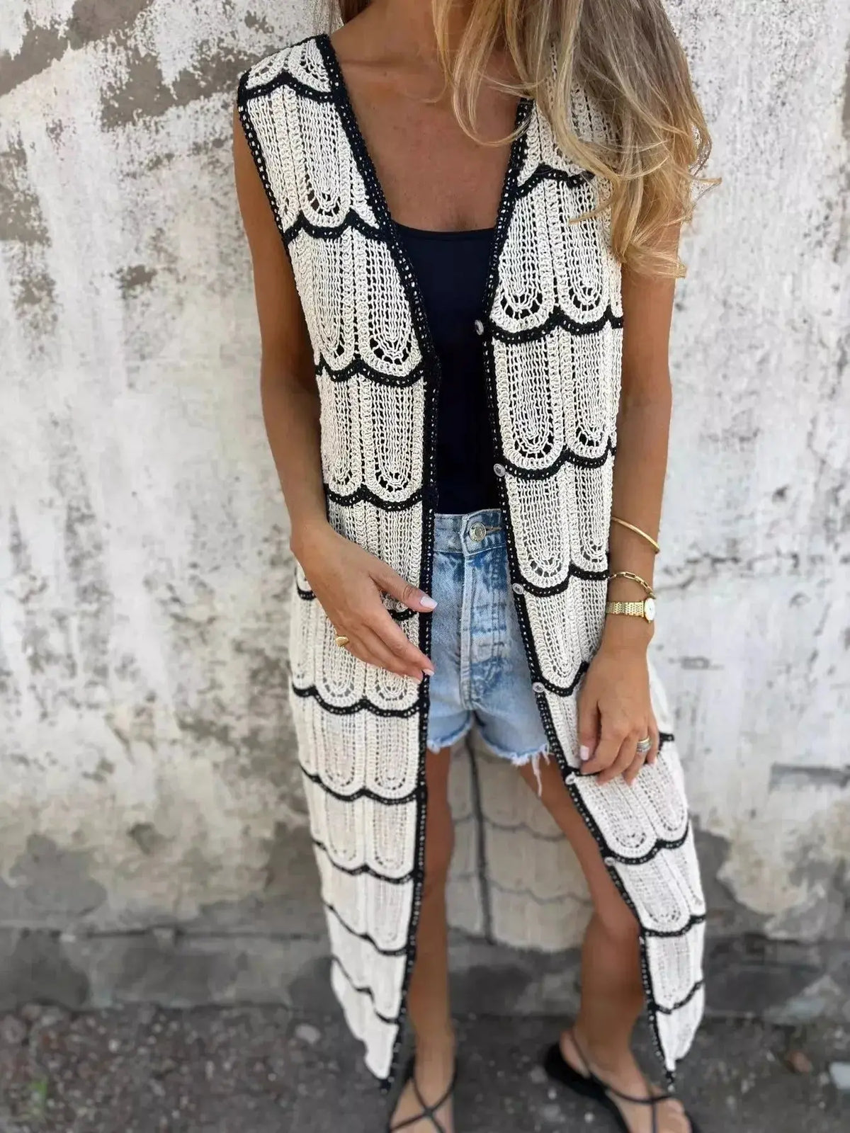 Women's sleeveless crochet longline cardigan by Plush Fashion Hub featuring openwork knit, button front, and casual vest style.