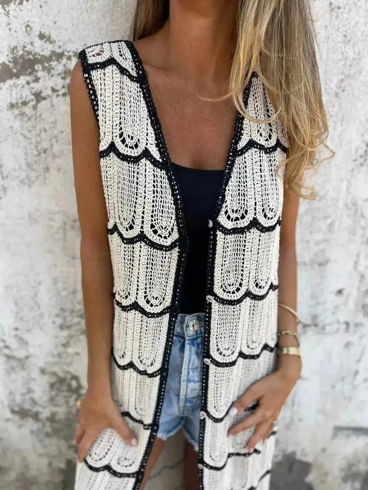 Women’s sleeveless crochet longline cardigan with openwork knit and button front, from Plush Fashion Hub, styled as a trendy sweater vest.