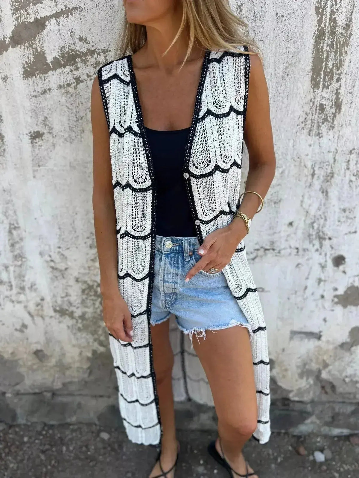 Women's sleeveless crochet longline cardigan by Plush Fashion Hub, openwork knit with button front, stylish vest for layered looks.
