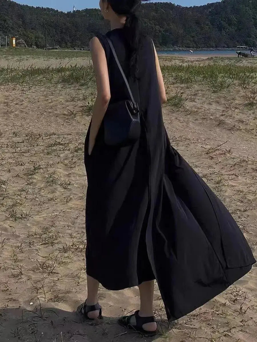 Women’s sleeveless irregular hem long dress by Plush Fashion Hub, solid color maxi dress with flowing, elegant style.
