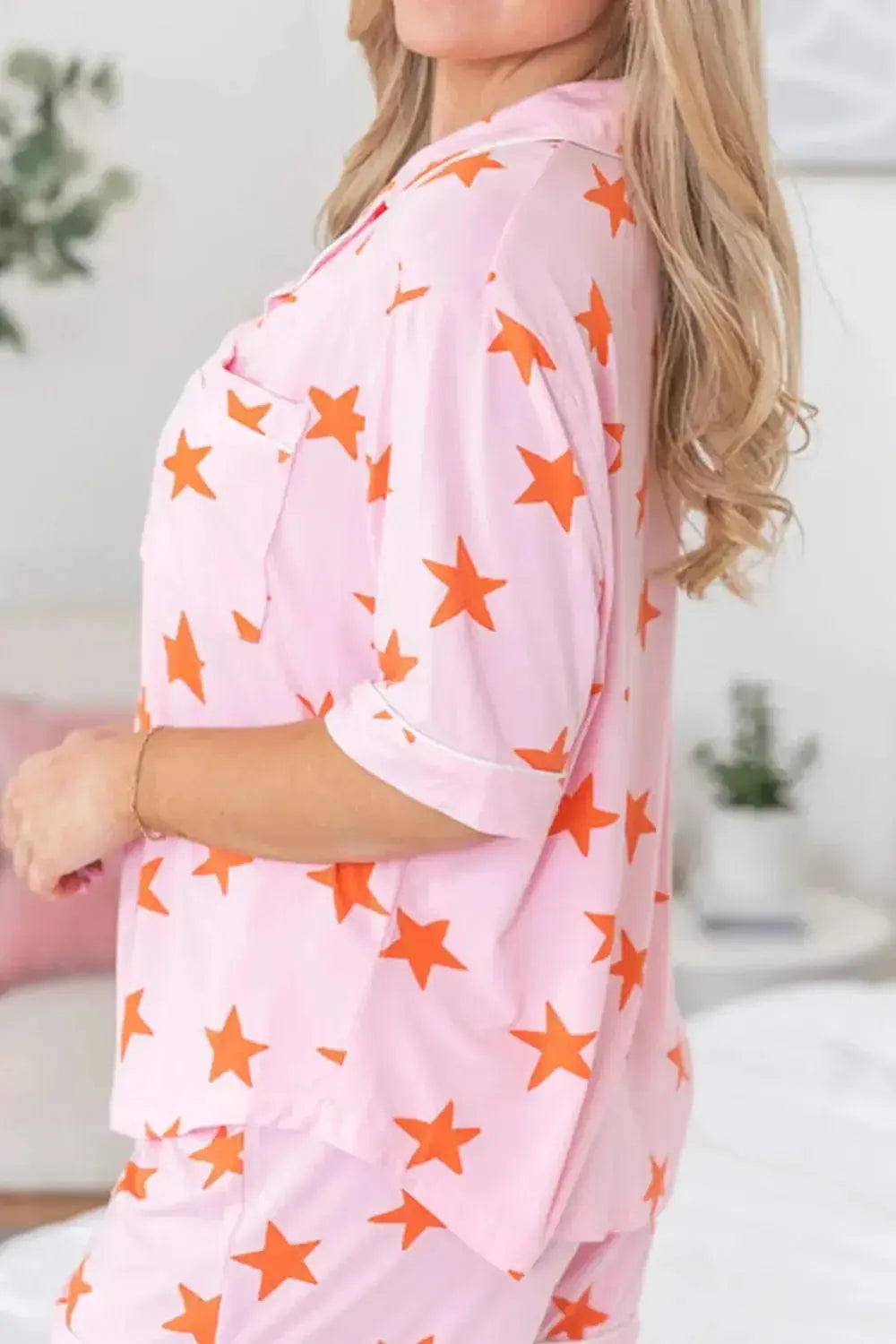 Women’s star print short sleeve button-down pajama set by Trendsi, featuring a comfortable, stylish design with star patterns.
