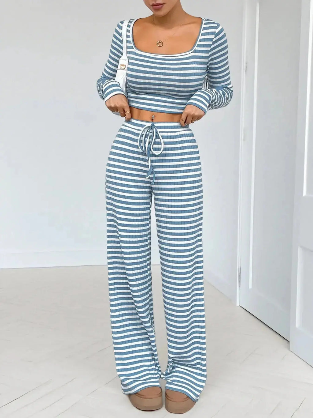Women's striped square neck long sleeve loungewear set with matching pants from Trendsi, soft and comfortable two-piece ensemble.