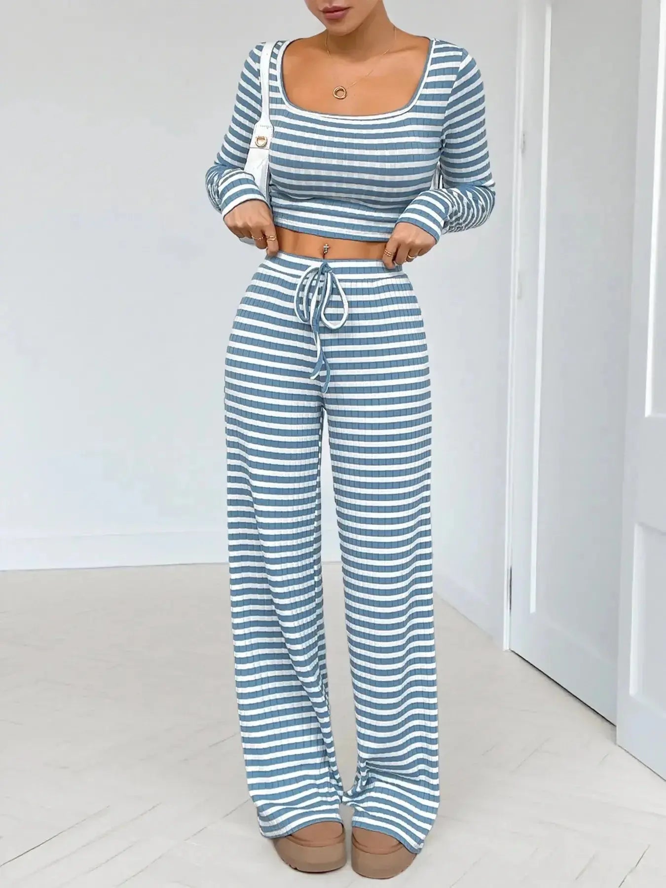 Women's striped square neck long sleeve loungewear set with matching pants from Trendsi, soft and comfortable two-piece ensemble.