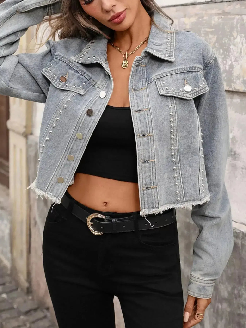 Women's distressed denim jacket with studded raw hem, stylish raw hem jean jacket by Trendsi, casual and trendy denim outerwear.