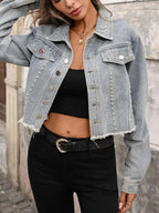 Women's distressed denim jacket with studded raw hem, stylish raw hem jean jacket by Trendsi, casual and trendy denim outerwear.