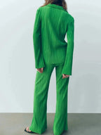 Women's textured long sleeve lounge set by Trendsi, cozy button-up pajama two-piece with soft fabric and relaxed fit.