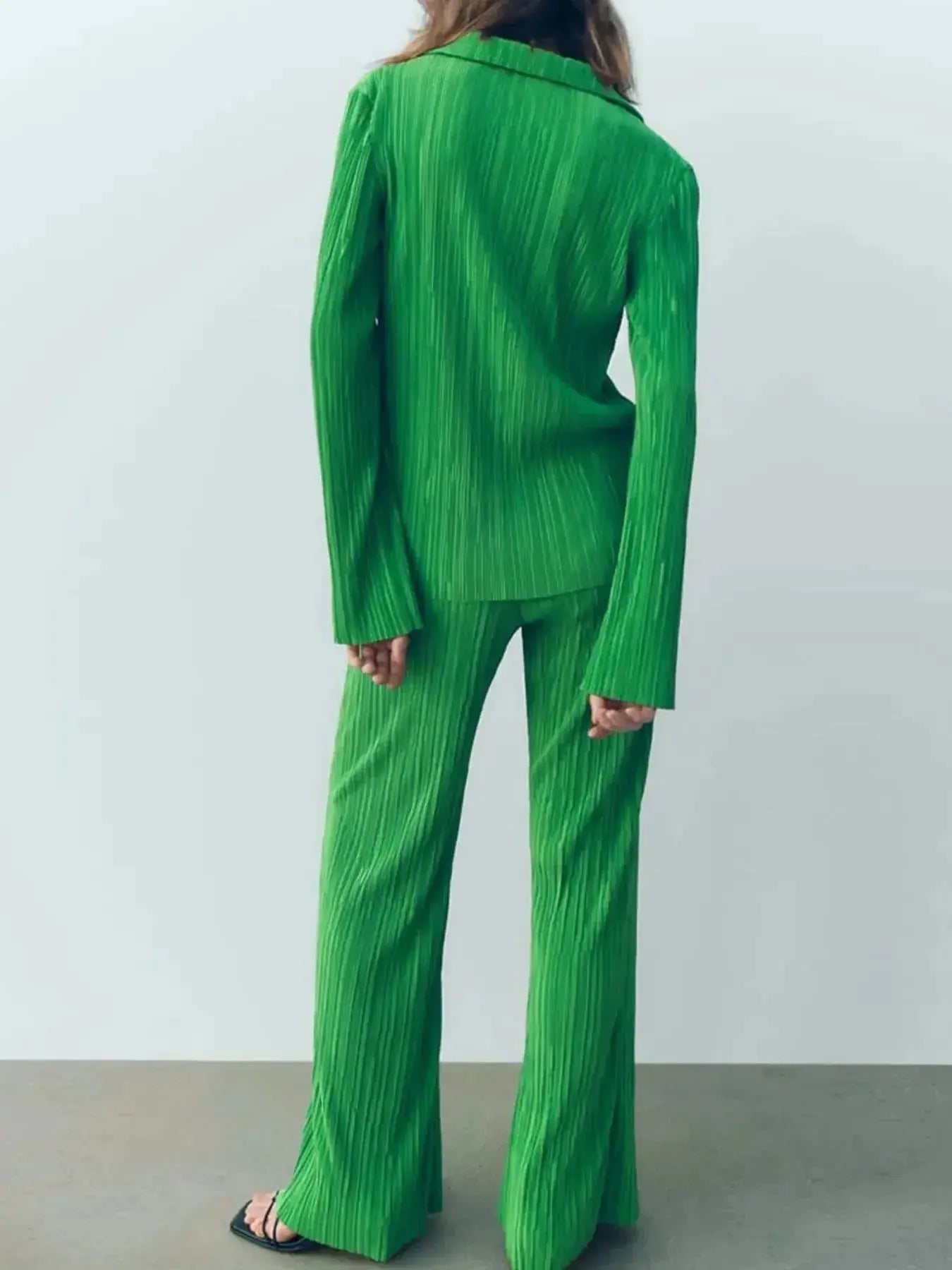 Women's textured long sleeve lounge set by Trendsi, cozy button-up pajama two-piece with soft fabric and relaxed fit.