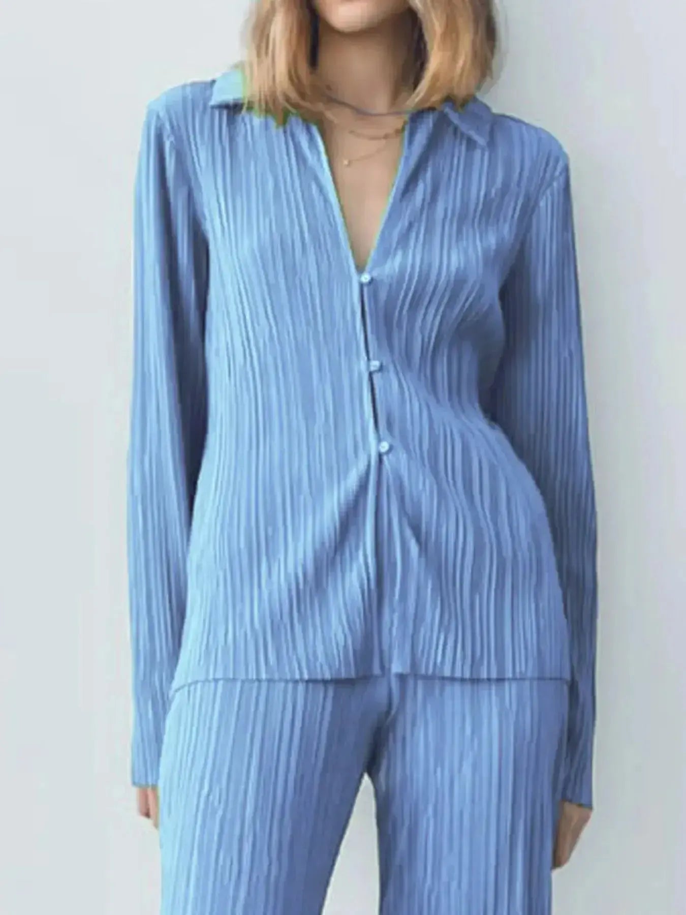 Women’s textured long sleeve lounge set by Trendsi featuring cozy button-up pajama top and matching pants, perfect for relaxing at home.