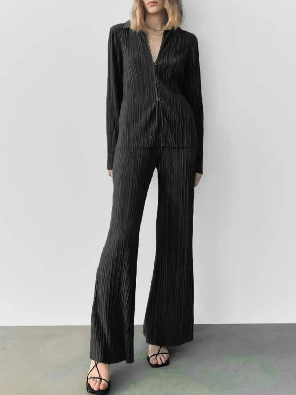 Women's textured long sleeve lounge set with cozy button-up pajama top and matching pants, stylish two-piece pajama from Trendsi.