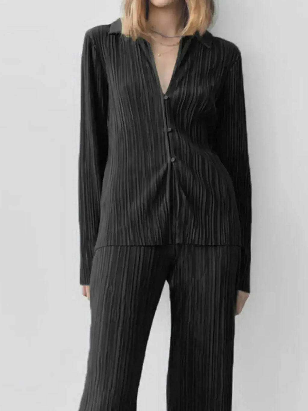 Women's textured long sleeve lounge set with cozy button-up pajama top and matching pants, stylish and comfortable for relaxing at home.