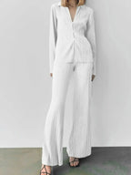 Women's textured long sleeve lounge set by Trendsi, cozy button-up pajama two-piece with soft fabric and relaxed fit.