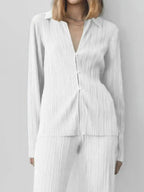 Women's textured long sleeve lounge set with cozy button-up top and matching pajama pants by Trendsi, perfect for relaxed nights.