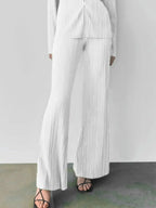 Women's textured long sleeve lounge set with cozy button-up top and matching pants, stylish pajama two-piece from Trendsi.