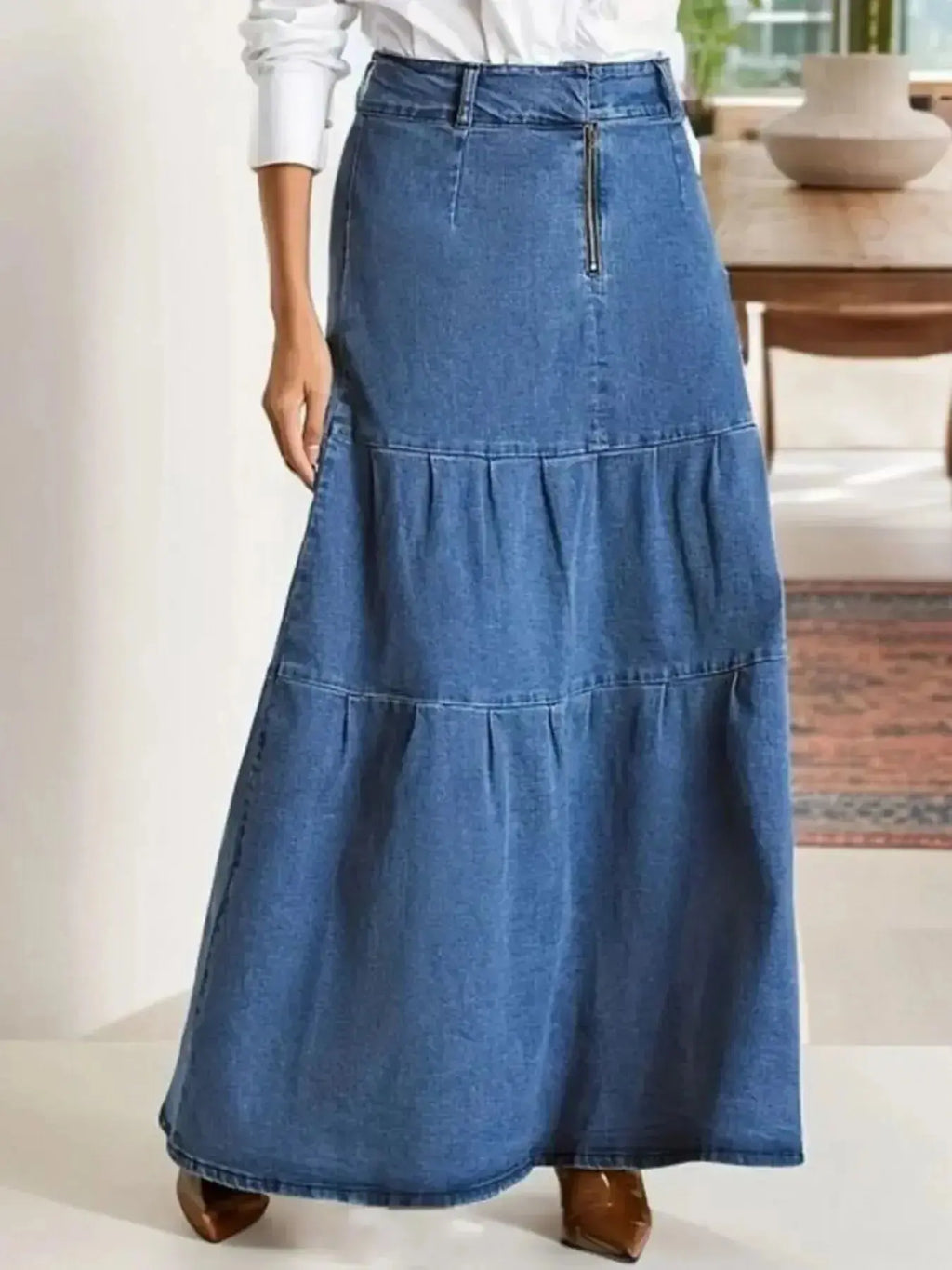 Women's tiered maxi denim skirt with ruched zipper detail from Trendsi, featuring a flowy design and stylish accents.
