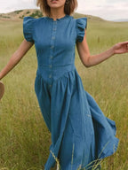 Women’s tiered ruffled cap sleeve denim dress by Trendsi, casual midi summer dress with ruffle details and a relaxed fit.