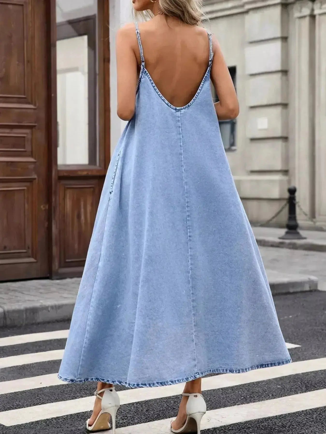 Women's V-neck denim cami mini dress by Trendsi, casual sleeveless cotton-blend denim dress with V-neck and mini length.