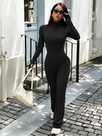 Women’s zip-up long sleeve active sweatsuit two-piece set by Trendsi, featuring a comfortable jacket and matching pants.