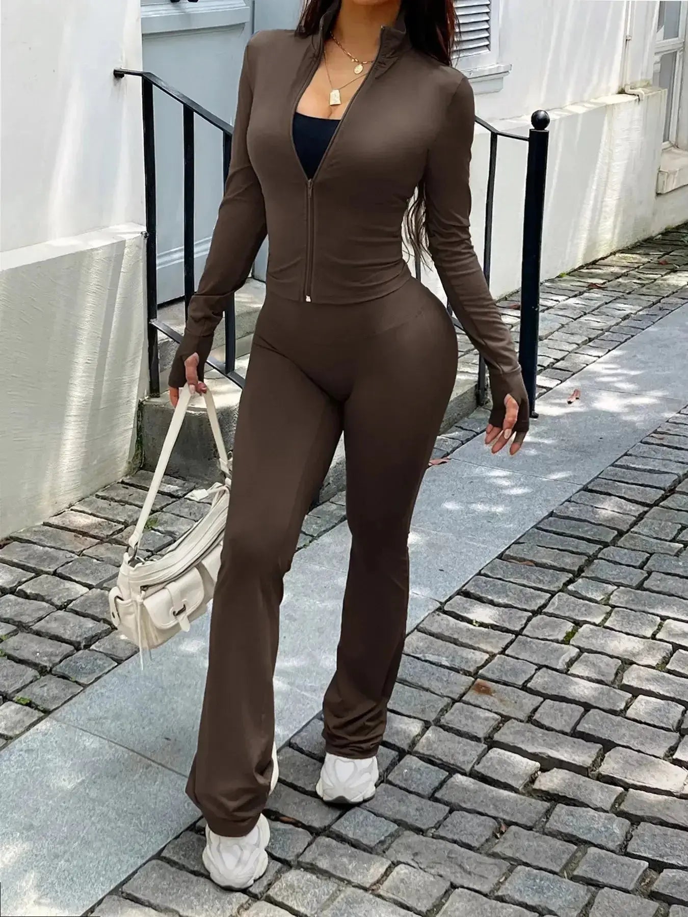 Women’s zip-up long sleeve active sweatsuit two-piece set by Trendsi, featuring a comfortable zip-up jacket and matching pants.
