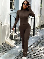 Women’s zip-up long sleeve active sweatsuit two-piece set by Trendsi, featuring a comfortable matching top and bottoms.