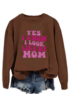 Cozy plush fashion sweatshirt with "Yes I Know I Look Like My Mom" graphic print, comfortable pullover from Plush Fashion Hub.