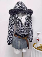 Zebra faux fur hooded zip-up jacket from Trendsi featuring plush fabric and stylish animal print design.