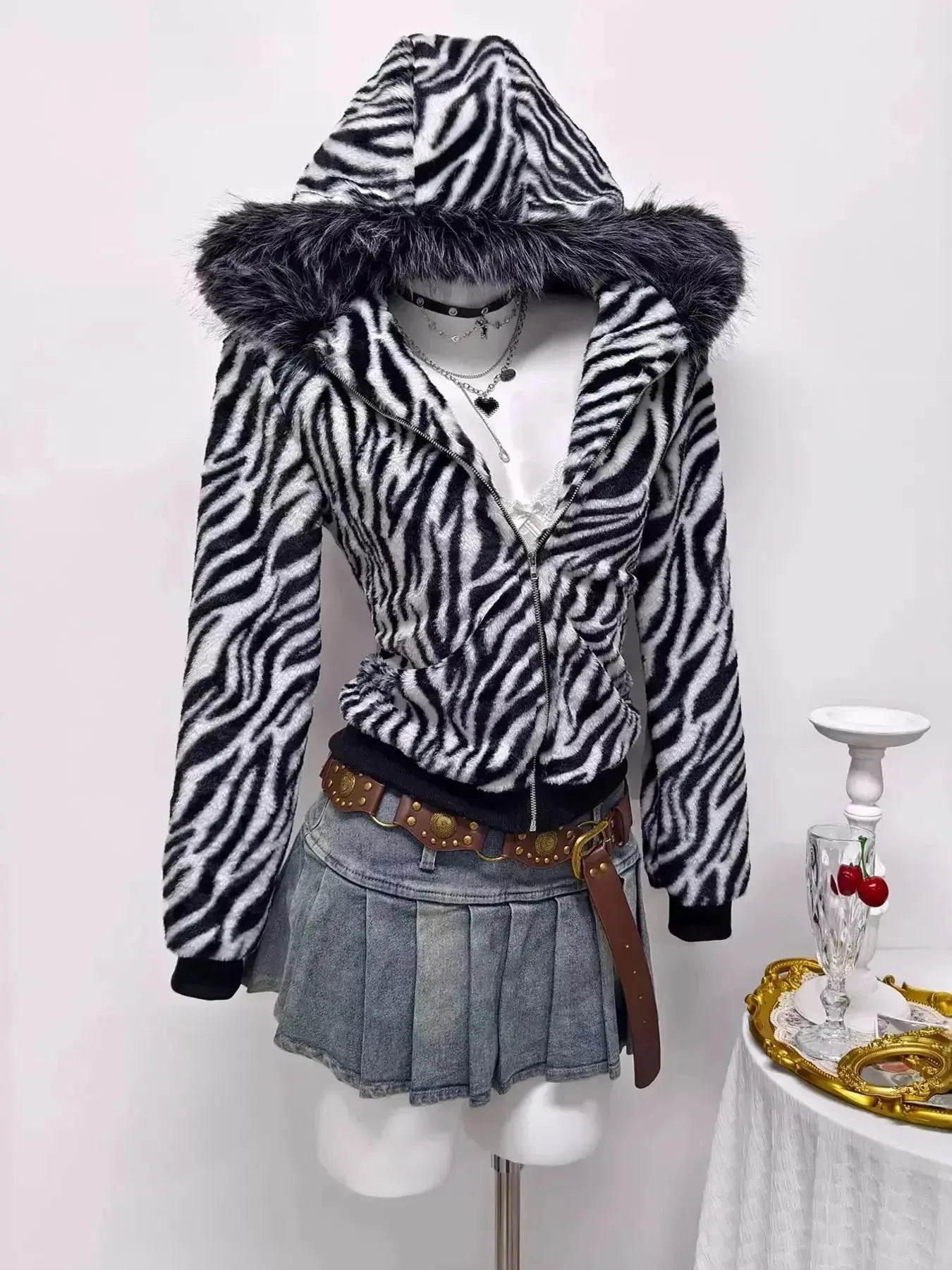 Zebra faux fur hooded zip-up jacket from Trendsi featuring plush fabric and stylish animal print design.