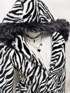 Zebra faux fur hooded zip-up jacket from Trendsi, plush and stylish with a furry zebra print, front zipper, and hood.