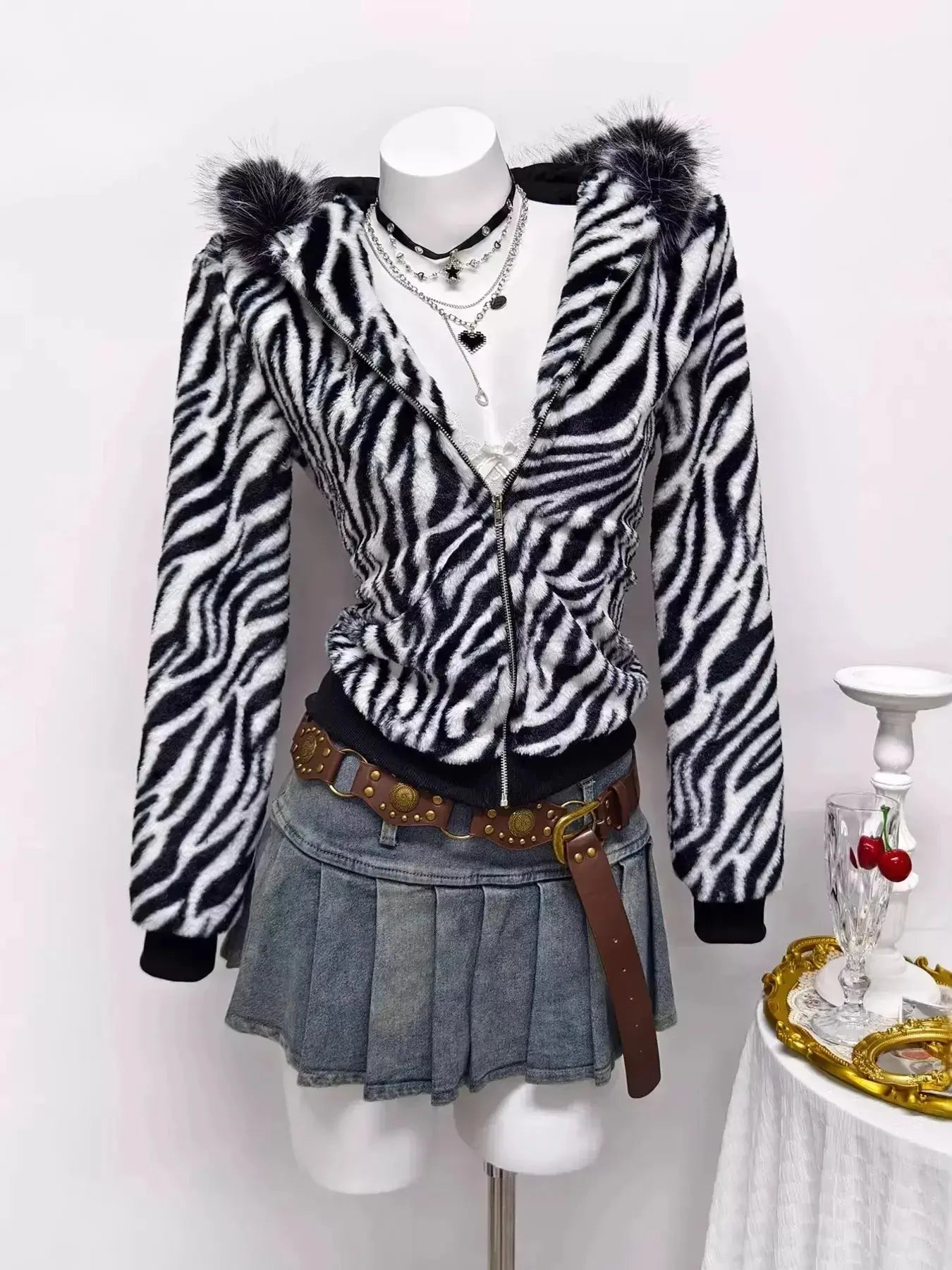 Zebra faux fur hooded zip-up jacket from Trendsi with plush texture and bold black-and-white zebra pattern.