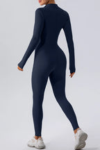 Black half zip mock neck active jumpsuit by Trendsi, designed for comfortable, stylish workout or casual wear.