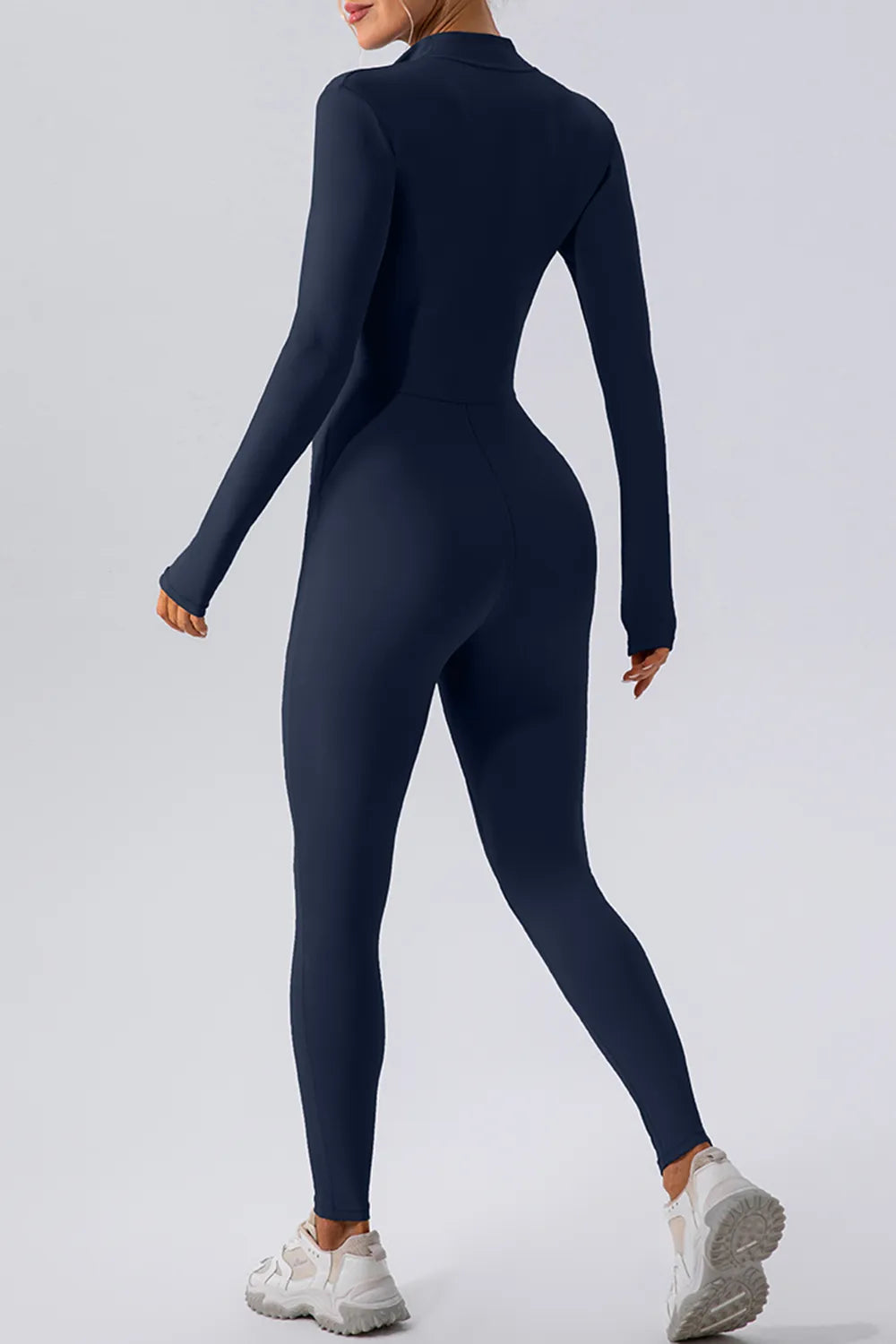 Black half zip mock neck active jumpsuit by Trendsi, designed for comfortable, stylish workout or casual wear.