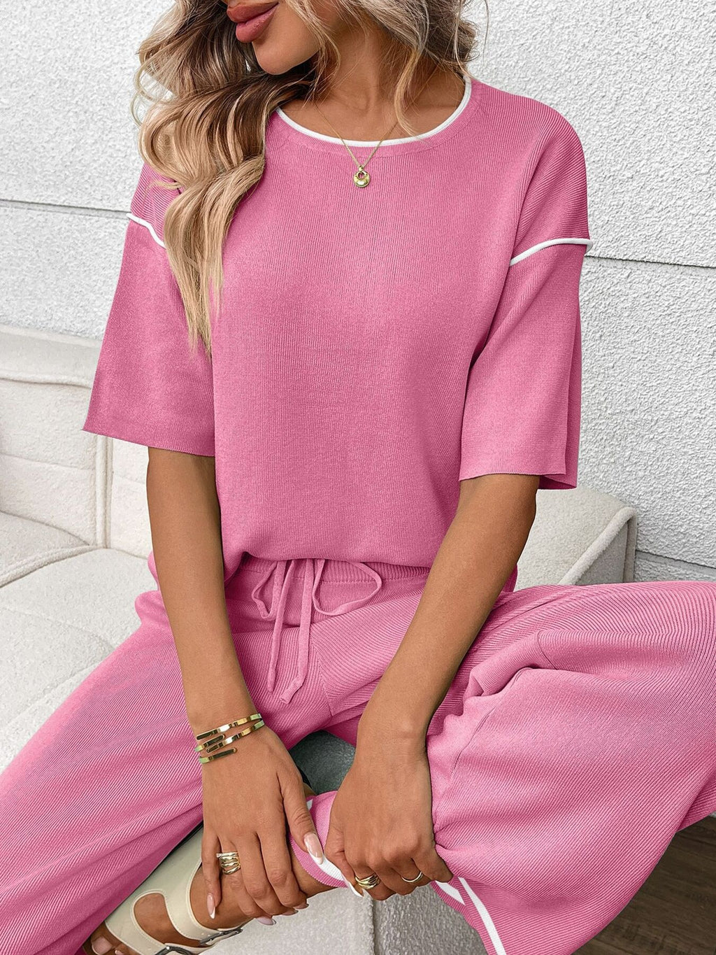 Women's casual two-piece lounge set with round neck top and drawstring pants by Trendsi, shown in a relaxed fit.