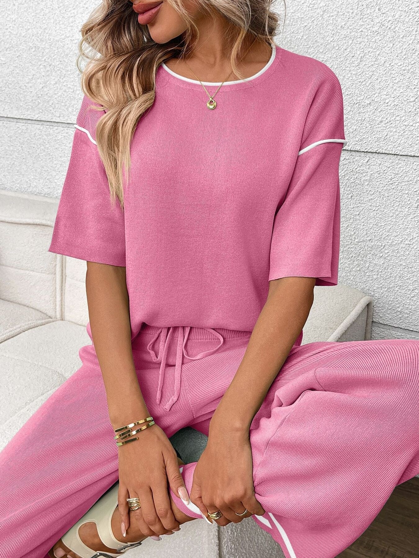 Women's casual two-piece lounge set with round neck top and drawstring pants by Trendsi, shown in a relaxed fit.
