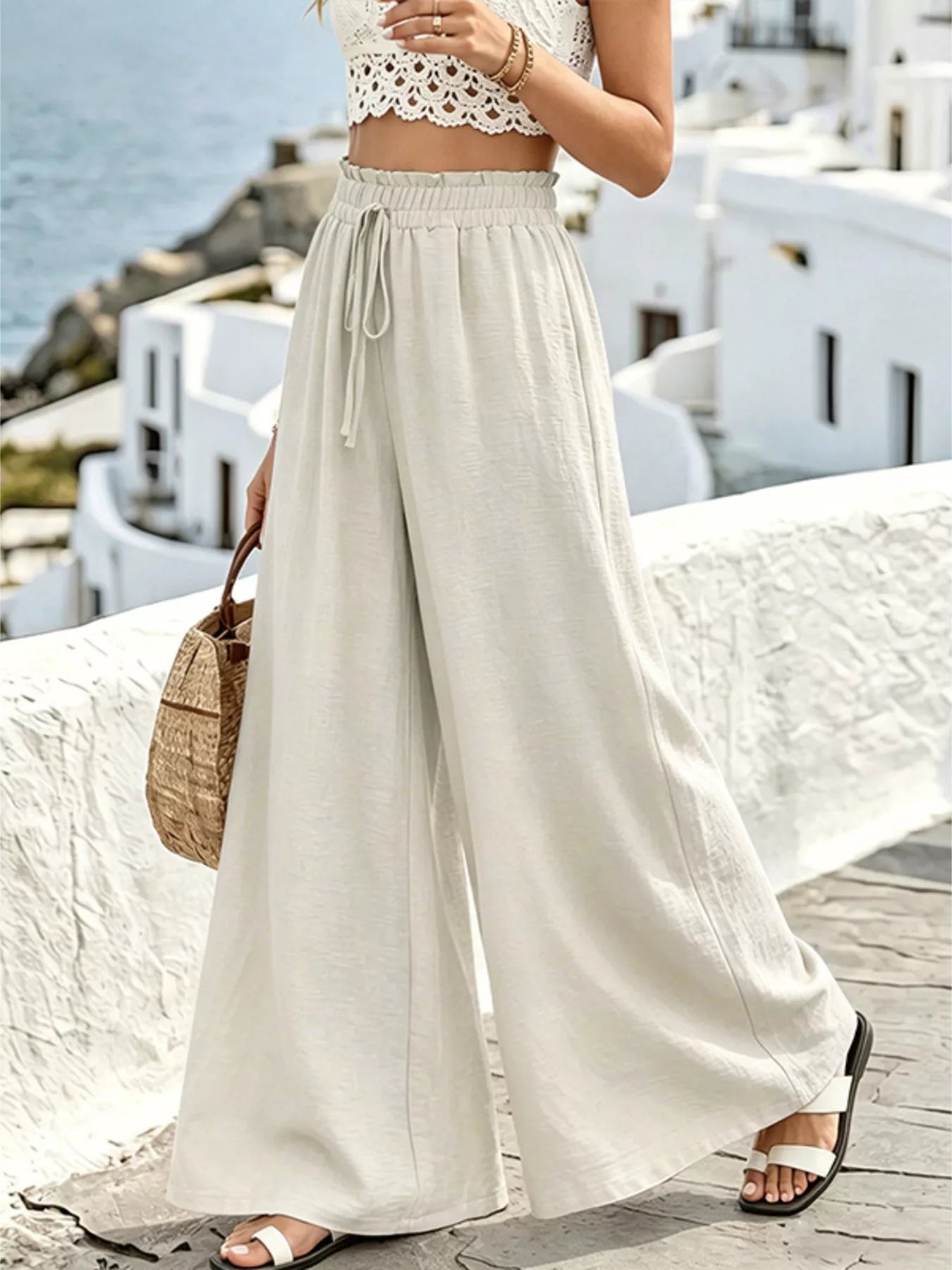 Wide leg drawstring pants by Plush Fashion Hub, featuring a relaxed fit and casual style, shown in a natural fabric and color.