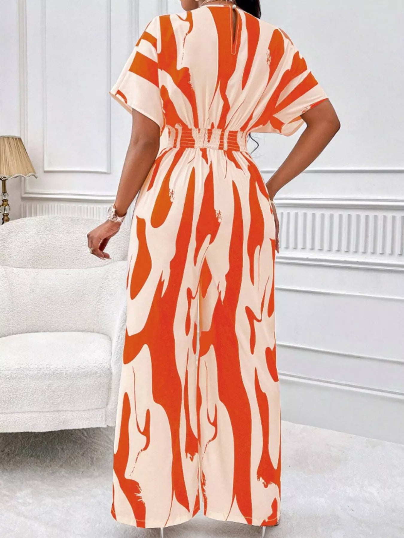 Abstract print wide-leg jumpsuit by Trendsi featuring a stylish, flowing design and bold artistic pattern.