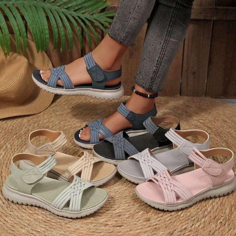 Women's open toe woven strap flat sandals by Trendsi, featuring comfortable faux leather slides with woven detailing.