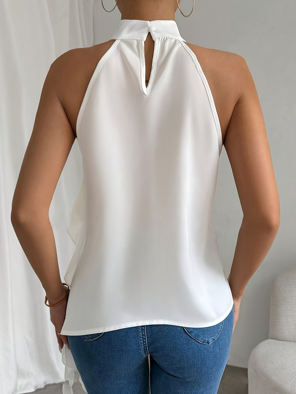 Chic ruffle halter neck sleeveless blouse for women, elegant office top by Trendsi, featuring ruffle detailing and a stylish halter design.