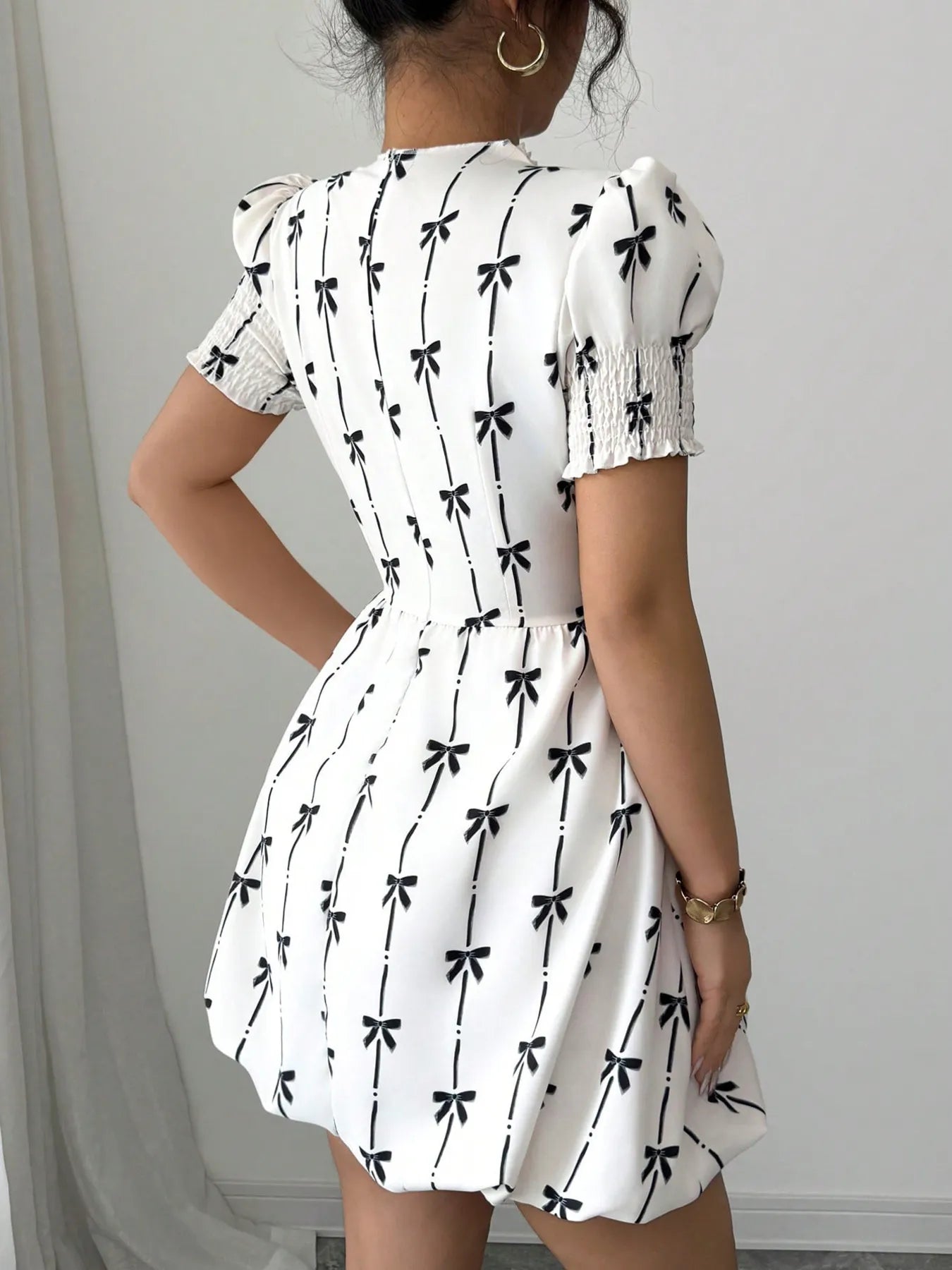 Smocked bow print short sleeve dress by Shopimist featuring a feminine, lightweight fabric with a charming bow detail.