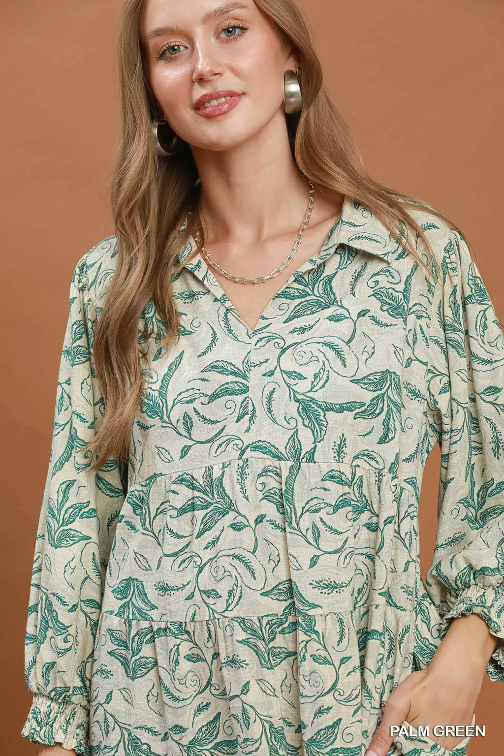 Linen botanical print tiered midi dress by Trendsi featuring a flowing silhouette and floral pattern, perfect for warm weather.