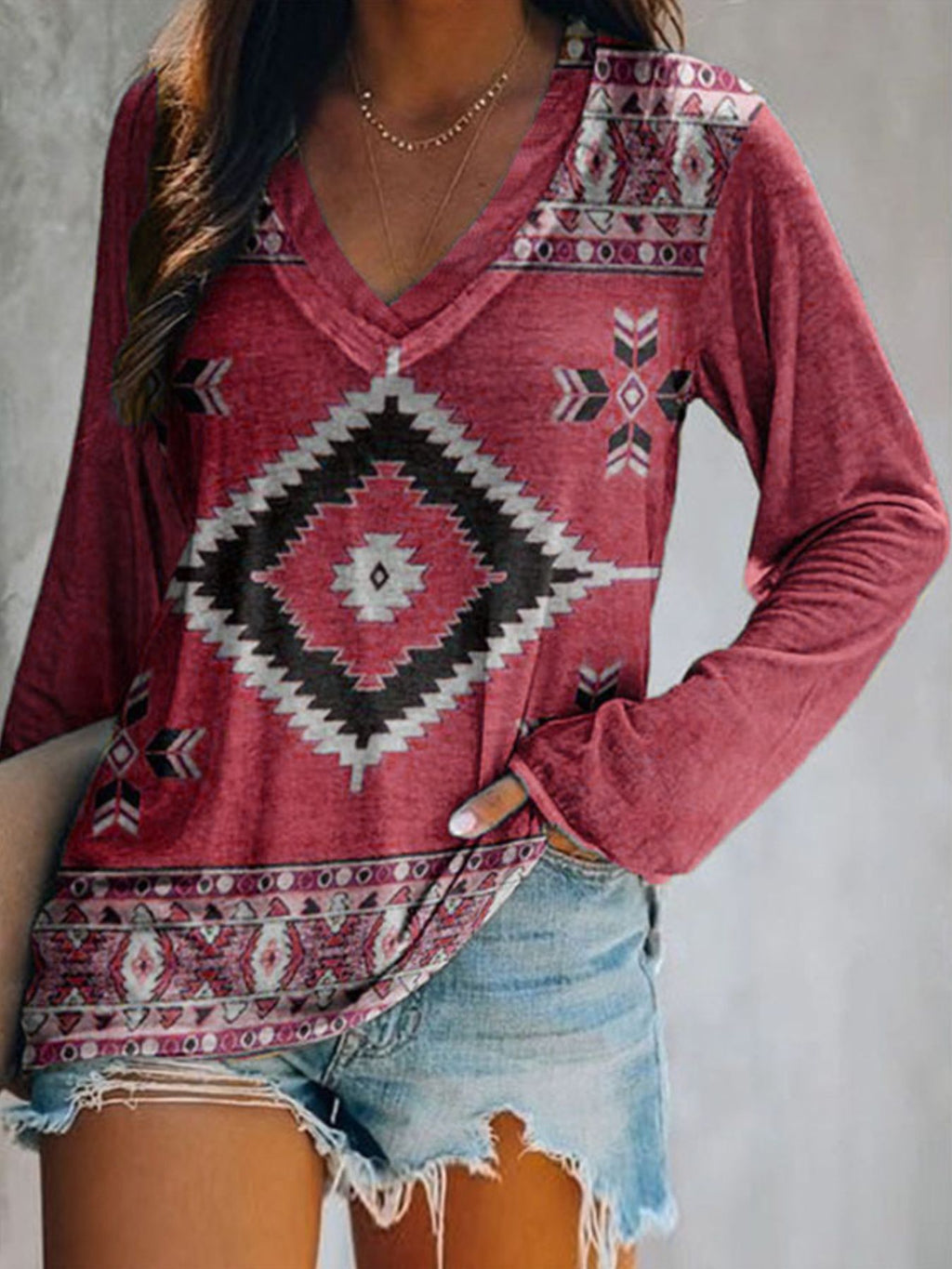 Plus size geometric print V-neck long sleeve T-shirt by Trendsi, featuring a comfortable casual fit and stylish design.
