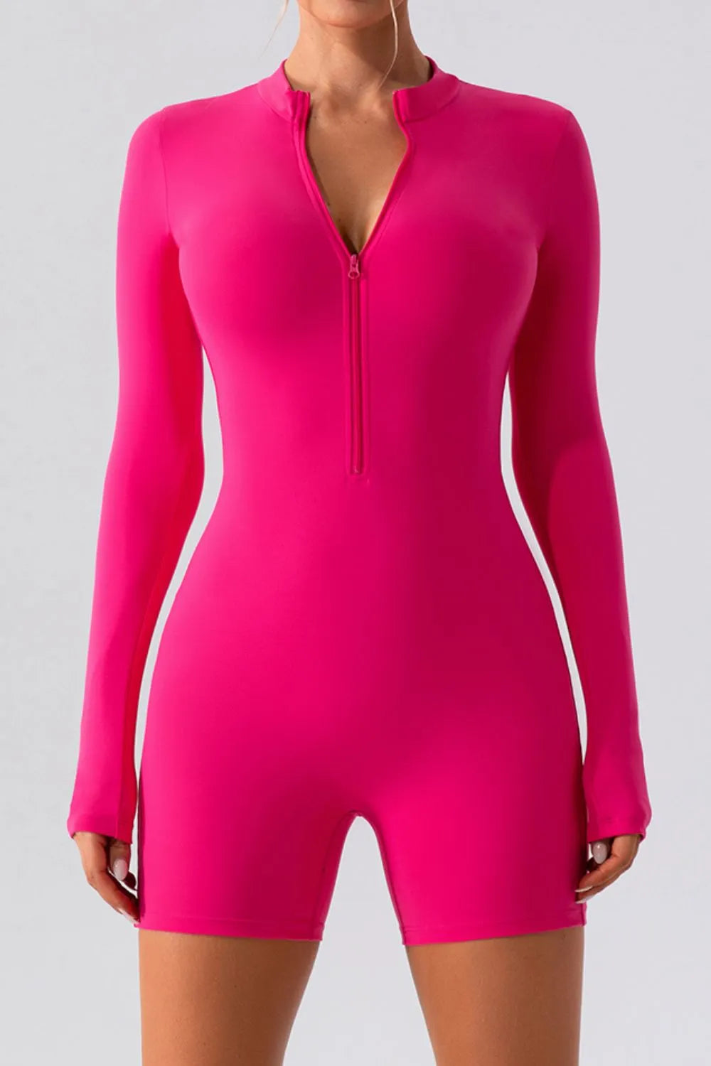 Gray half zip long sleeve active romper by Trendsi, made for comfortable athletic wear, shown on a model.