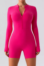 Gray half zip long sleeve active romper by Trendsi, made for comfortable athletic wear, shown on a model.