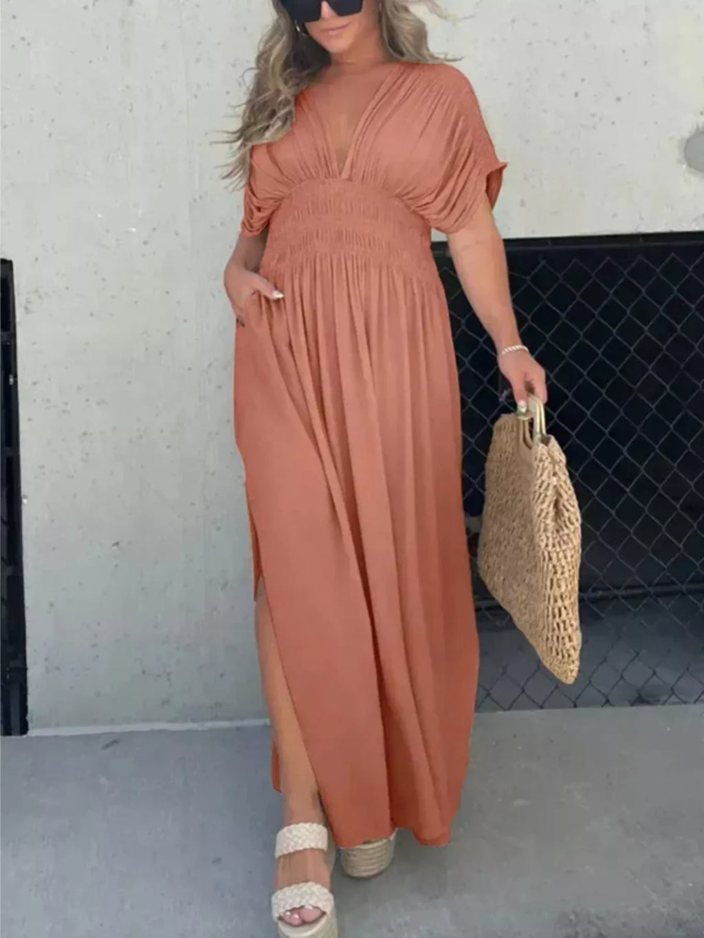 Plus size maxi dress with slit, V-neckline, and smocked waist by Trendsi, featuring a flowy fabric and elegant design.