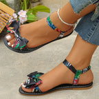 Floral bowknot ankle strap flat sandals by Trendsi, comfortable women's summer shoes with open toe design and floral accents.
