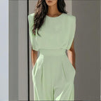 Women’s casual FitiqueFit wide-leg short sleeve jumpsuit hanging on a hanger, showcasing relaxed fit and stylish design.