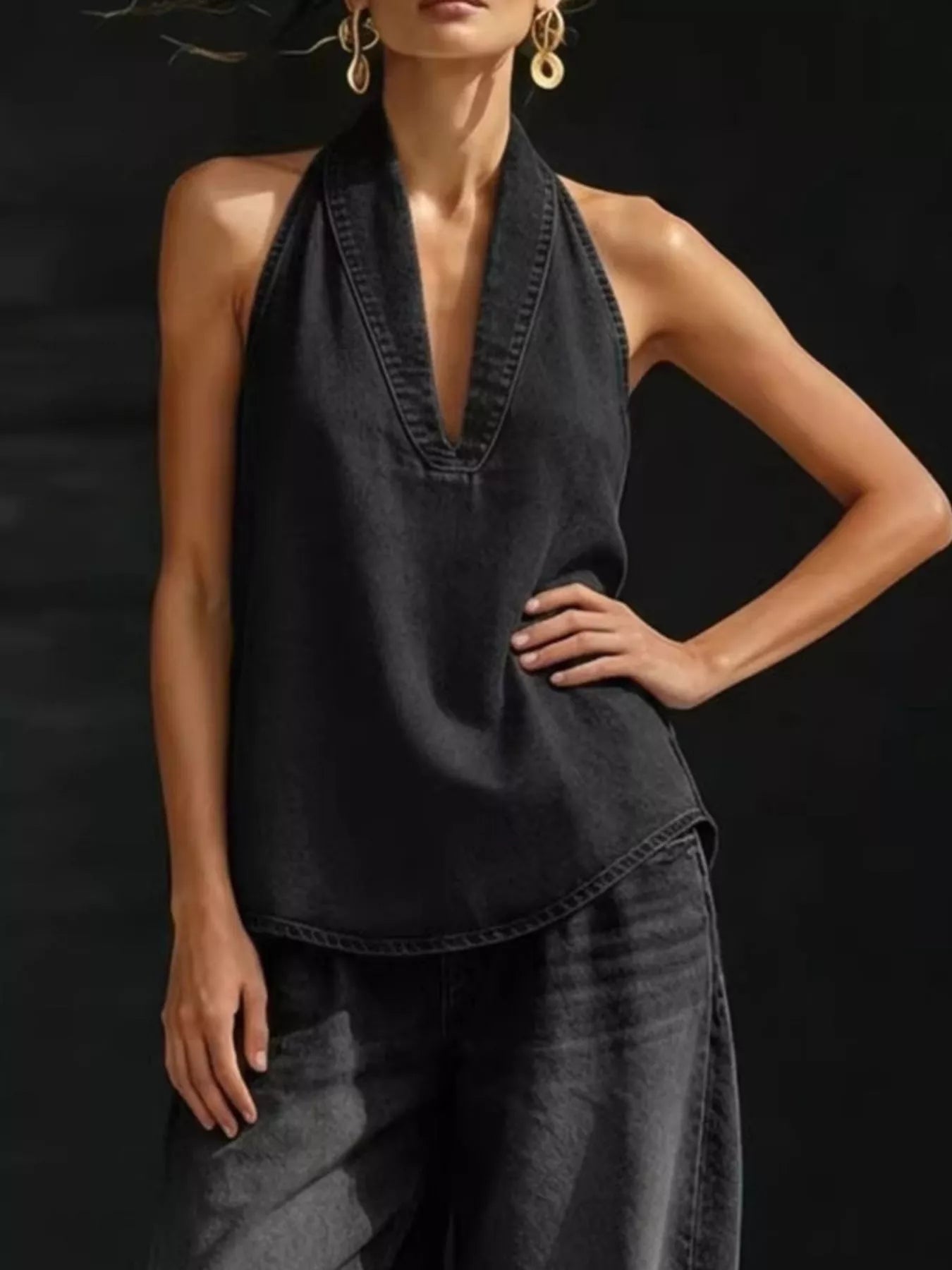 Plus size women's halter neck top and wide-leg pants two-piece set by Trendsi, featuring a stylish dress with a halter neckline and flowing pants.