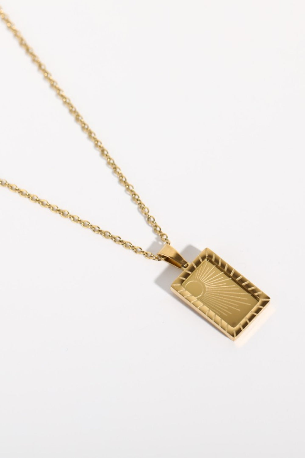 Stainless steel 18K gold-plated necklace with a sleek chain and pendant, featuring a shiny, polished finish.