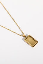 Stainless steel 18K gold-plated necklace with a sleek chain and pendant, featuring a shiny, polished finish.