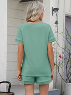 Solid color short sleeve top and shorts two-piece set by Trendsi, casual summer outfit with comfortable fabric and simple design.