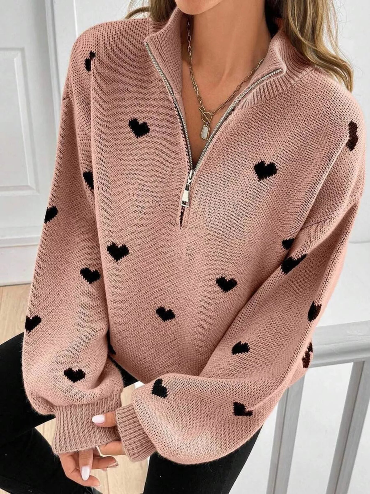 Plus size full heart half-zip long sleeve sweater by Trendsi, showing a cozy, stylish sweater with a heart detail and half-zip closure.